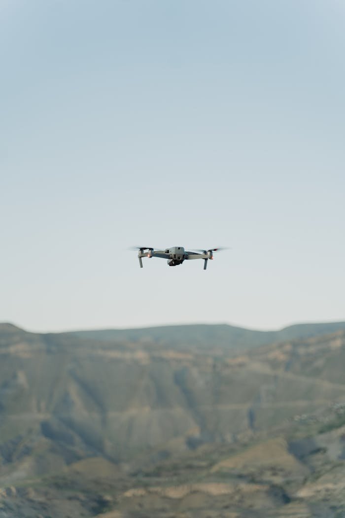 A drone flying over impressive mountains, perfect for technology and nature themes.